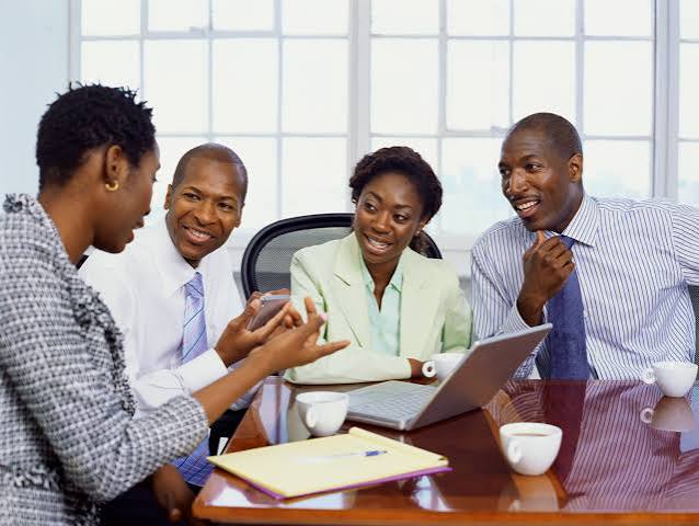 Colleagues discussing growth charts during a strategy meeting