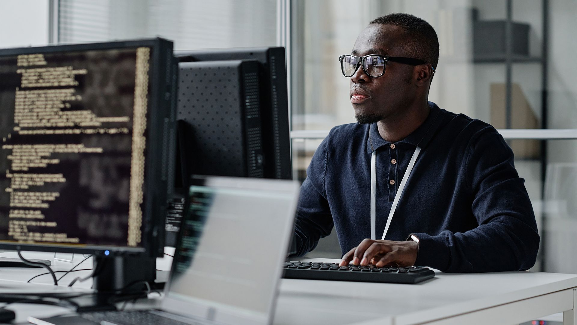 African software engineer coding in a modern office